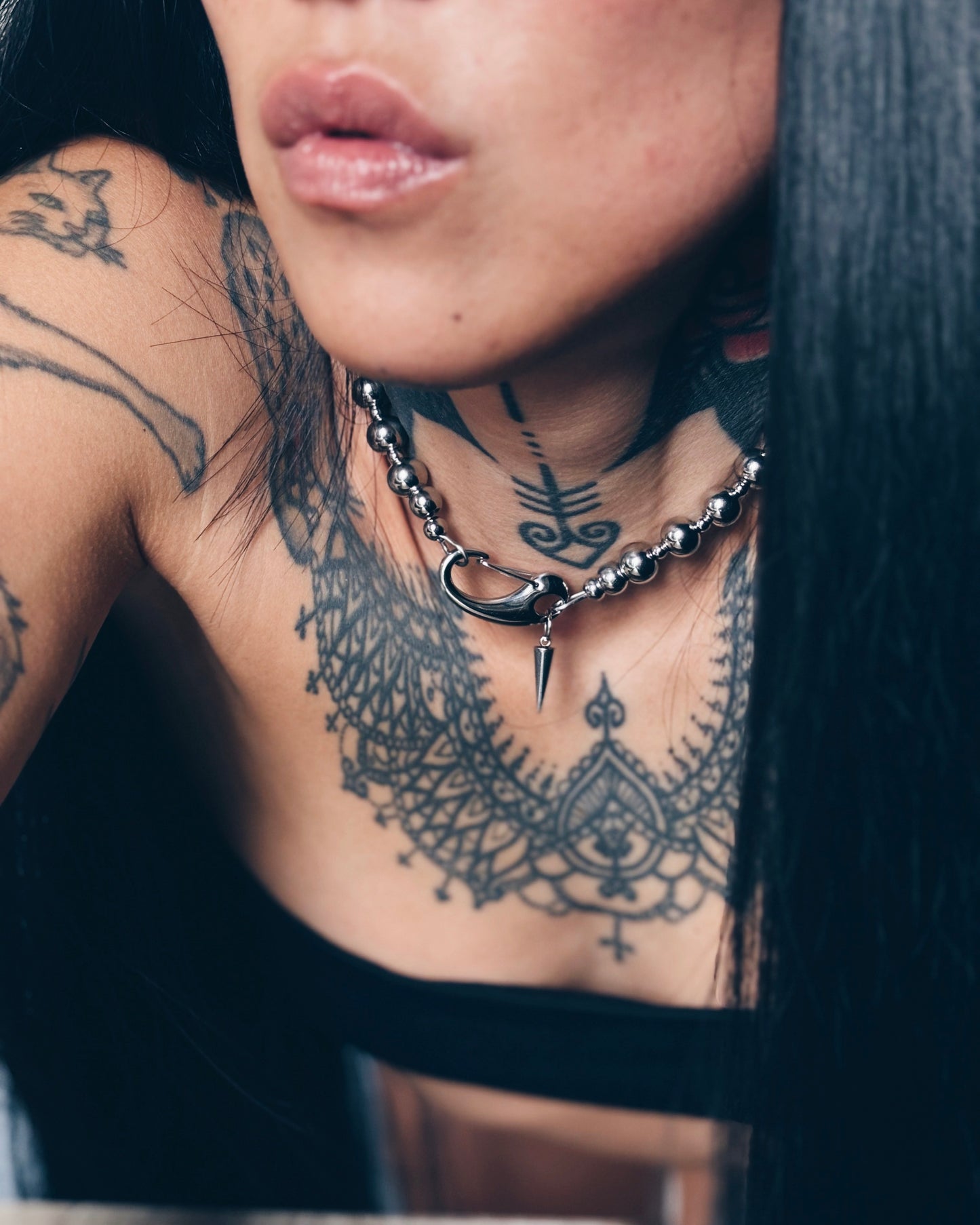 Woman wearing chrome pearl necklace